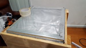 Cut your oven bag open, so it is a single layer of plastic, and attach it to you lid. Make sure there are no unsealed bits where hot air could escape.