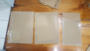 Cut rectangles for the three main sides. For added strength, tape a scrap piece of cardboard to the back of each panel.